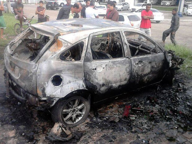 Motorista sai ileso após carro bater em caminhão e pegar fogo
